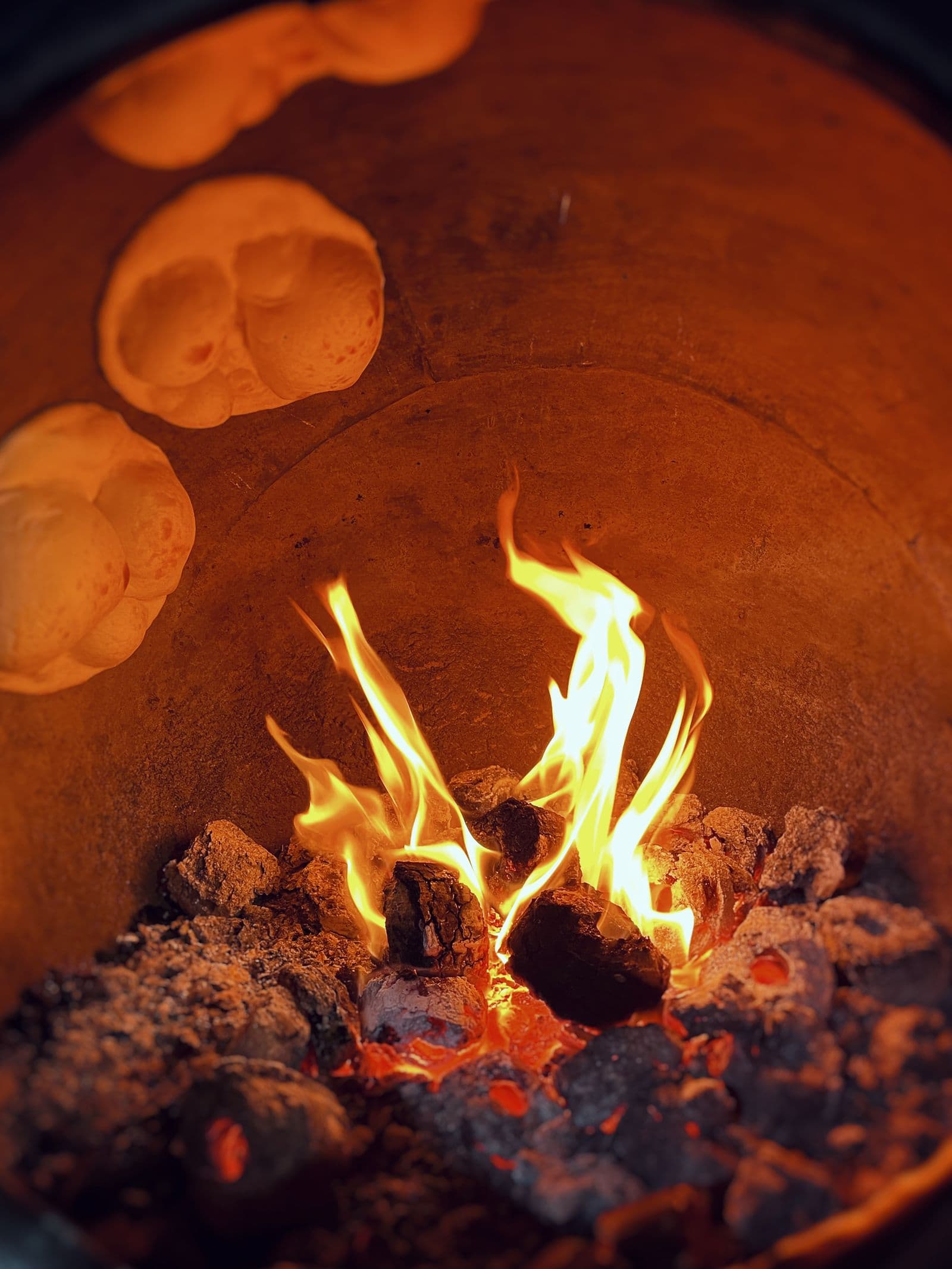 Flames inside a clay tandoor oven